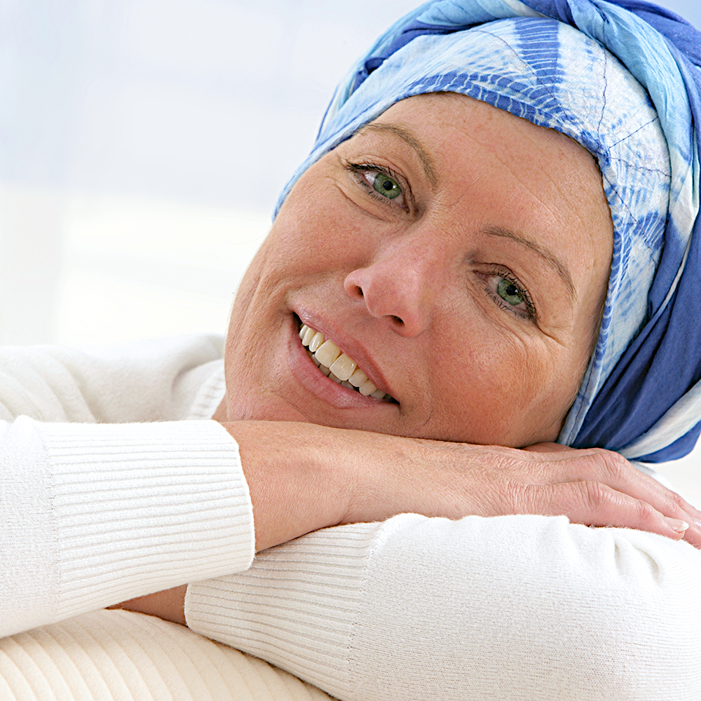 woman wearing head scarf and smiling