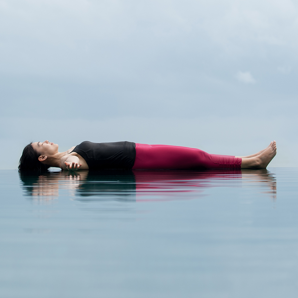 Woman appearing to lay down on surface of water