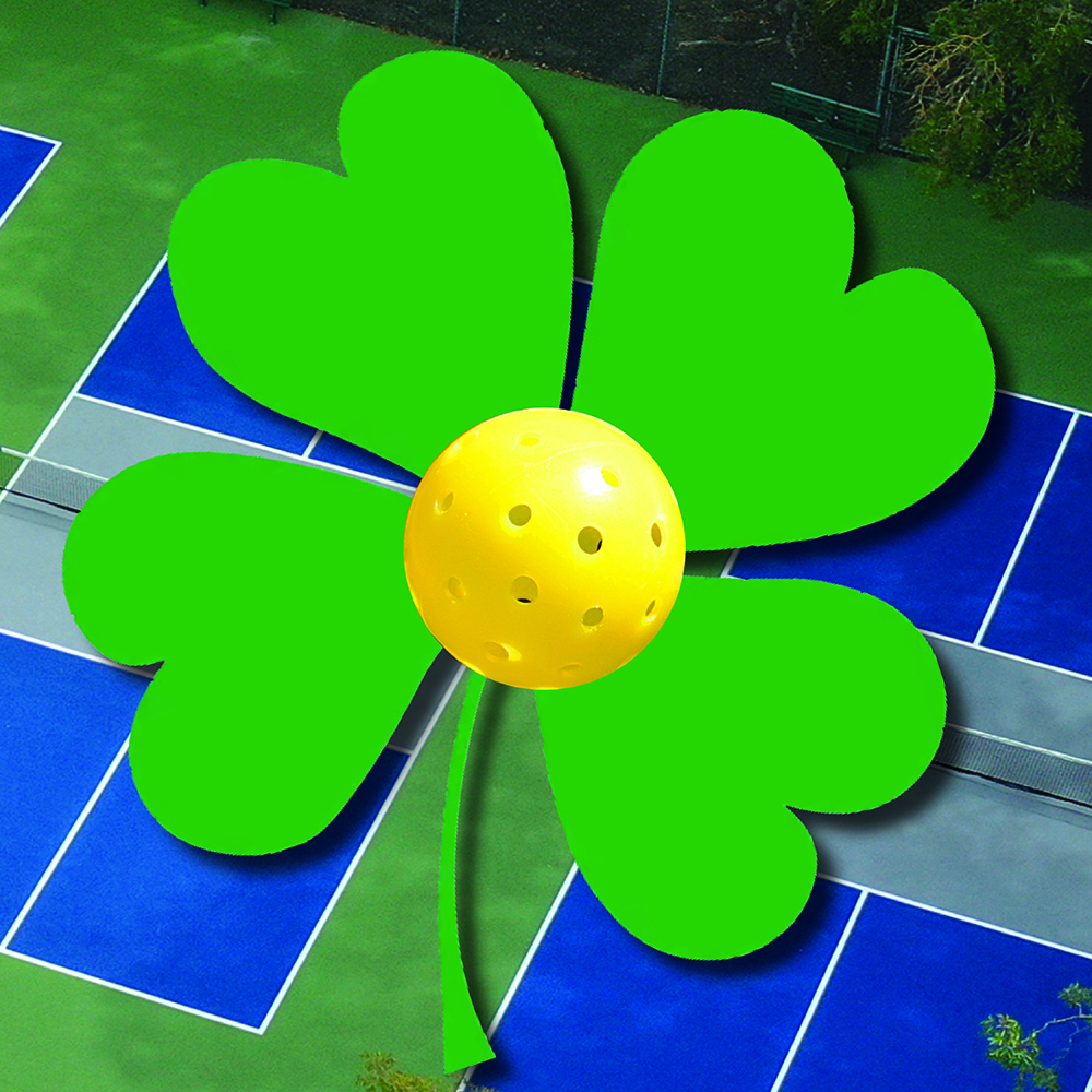 Yellow pickleball on green clover over pickleball courts background
