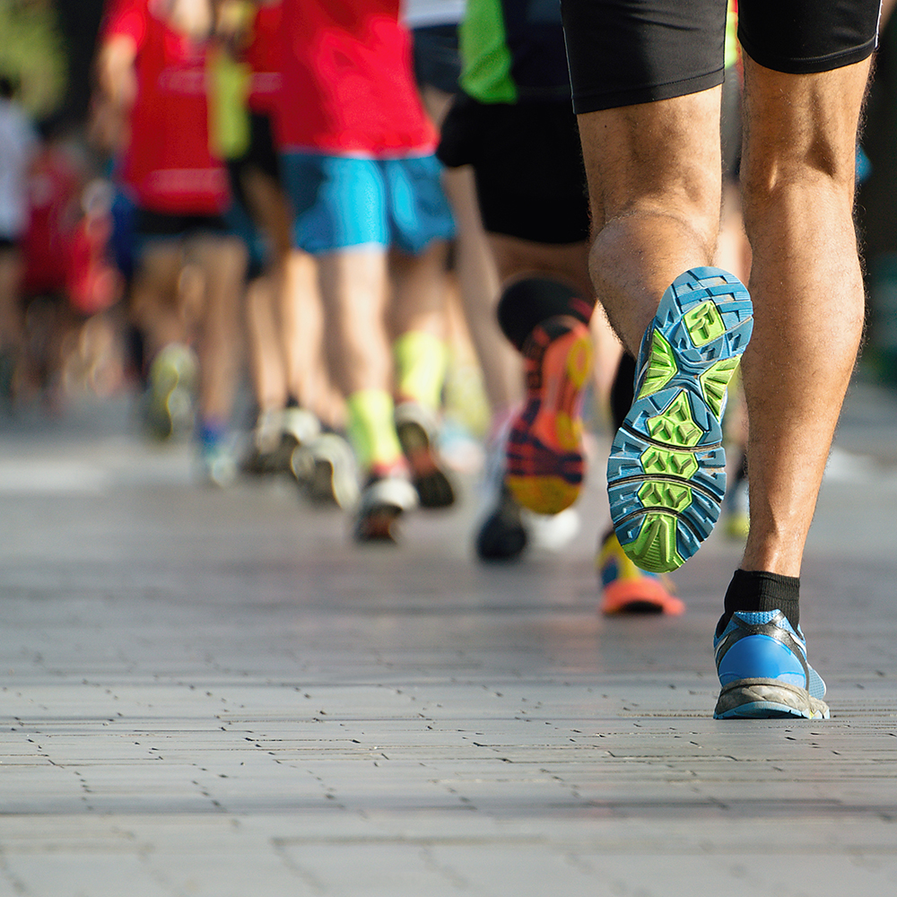 Marathon running race, people feet on city road