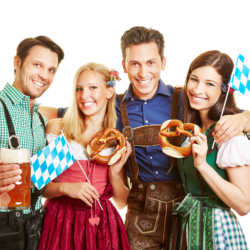 people in lederhosen with pretzels and beer