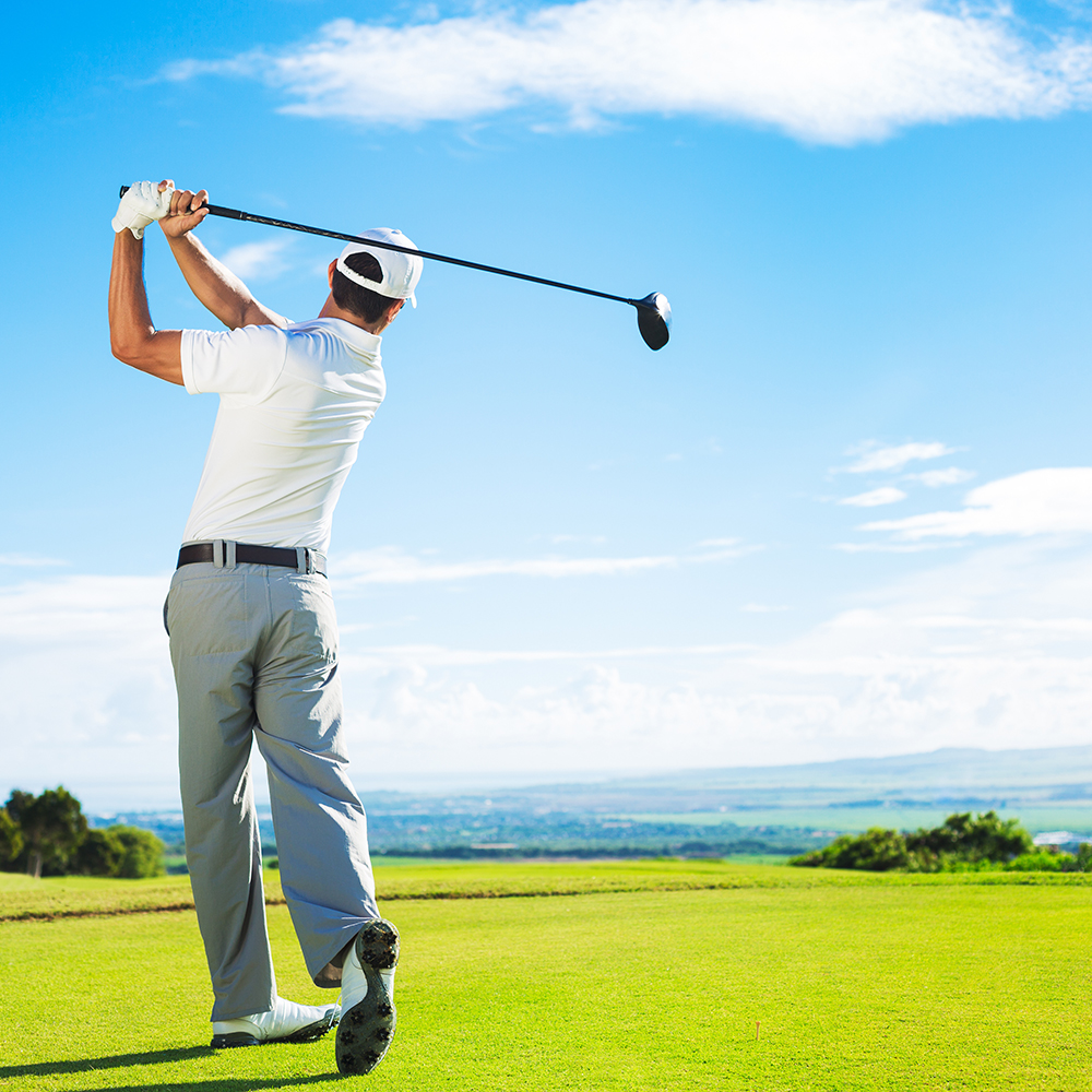 man golfing against blue sky background