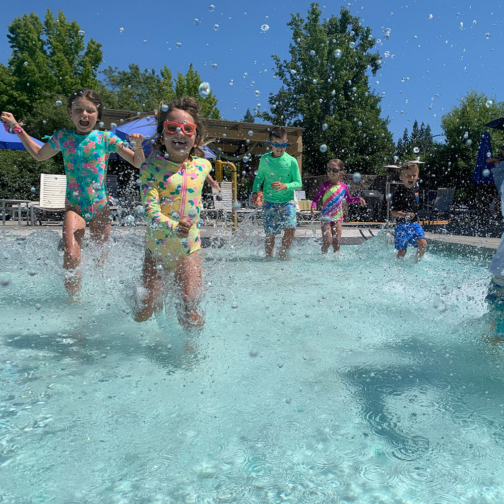 kids splashing in pool